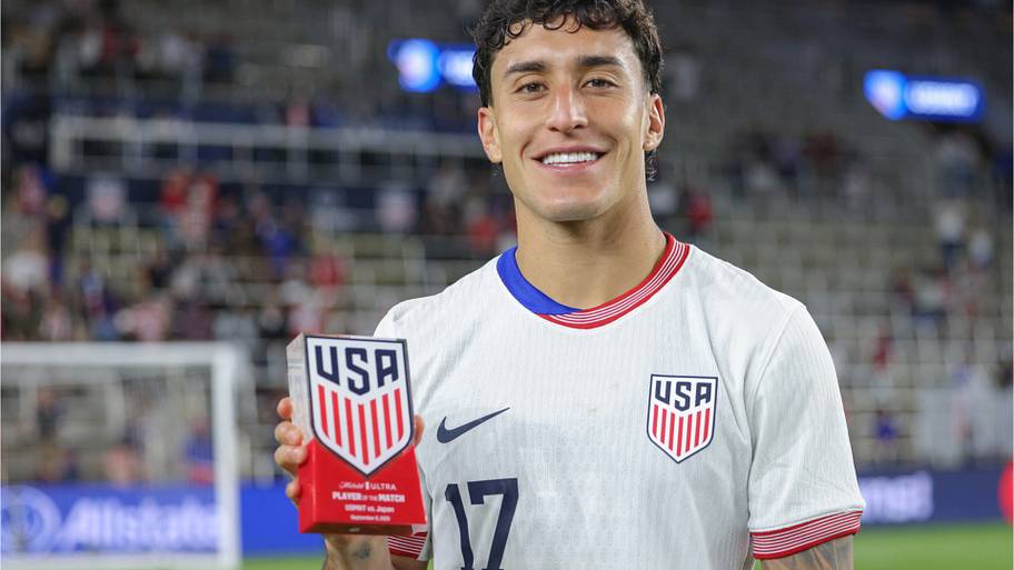 Alex Zendejas posing with a trophy.