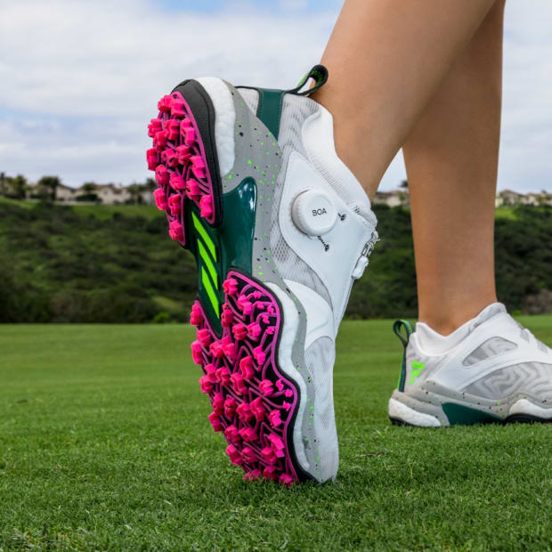 White and grey adidas golf shoes.