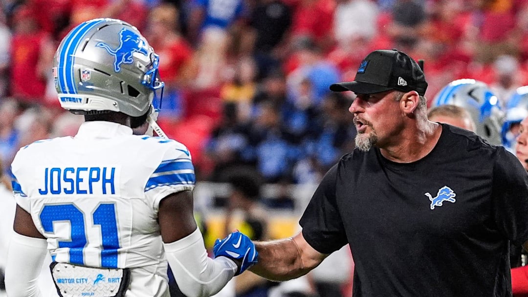 Detroit Lions head coach Dan Campbell shakes hands with safety Kerby Joseph (31) during warm up at Arrowhead Stadium in Kansas City, Missouri on Sunday, Oct. 12, 2025.