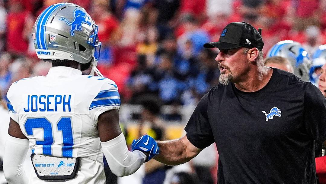 Detroit Lions head coach Dan Campbell shakes hands with safety Kerby Joseph (31) during warm up at Arrowhead Stadium in Kansas City, Missouri on Sunday, Oct. 12, 2025.
