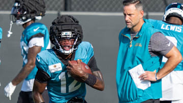 Jacksonville Jaguars wide receiver Travis Hunter (12) runs a drill as Jacksonville Jaguars Defensive Coordinator Anthony Campanile watches during the Jaguars 14th NFL training camp session at Miller Electric Center Tuesday August 12, 2025 in Jacksonville, Fla. The Jaguars travel to New Orleans to play the Saints this Sunday in their second preseason game. [Doug Engle/Florida Times-Union]