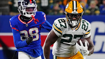 Former Green Bay Packers running back Patrick Taylor (27) runs the ball against New York Giants cornerback Cor'Dale Flott (28) during the second quarter at MetLife Stadium.