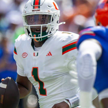 Florida defensive end Tyreak Sapp (94) pressures Miami Hurricanes quarterback Cam Ward (1) during the season opener at Ben Hill Griffin Stadium in Gainesville, FL on Saturday, August 31, 2024 against the University of Miami Hurricanes in the first half. [Doug Engle/Gainesville Sun]