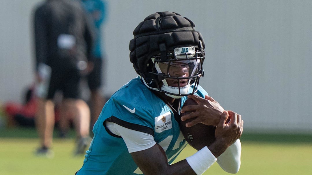 Jacksonville Jaguars wide receiver Travis Hunter (12) tucks the ball after running a route during the Jaguar’s 12th NFL training camp session at the Miller Electric Center, Thursday, Aug. 7, 2025, in Jacksonville, Fla. 