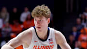 Mar 7, 2025; Champaign, Illinois, USA;  Illinois Fighting Illini guard Kasparas Jakucionis (32) drives the ball during the first half against the Purdue Boilermakers at State Farm Center. Mandatory Credit: Ron Johnson-Imagn Images