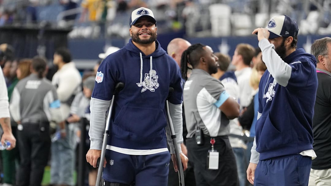 Nov 28, 2024; Arlington, Texas, USA;  Dallas Cowboys quarterback Dak Prescott (left) stands on crutches before the game against the New York Giants at AT&T Stadium. Mandatory Credit: Chris Jones-Imagn Images
