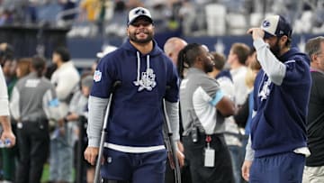 Nov 28, 2024; Arlington, Texas, USA;  Dallas Cowboys quarterback Dak Prescott (left) stands on crutches before the game against the New York Giants at AT&T Stadium. Mandatory Credit: Chris Jones-Imagn Images