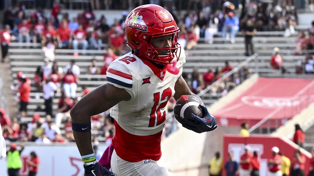 Oct 18, 2025; Houston, Texas, USA; Arizona Wildcats wide receiver Tre Spivey (12) runs the ball in for a touchdown during the fourth quarter against the Houston Cougars at TDECU Stadium. Mandatory Credit: Maria Lysaker-Imagn Images 