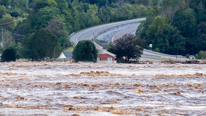 Flood waters from the Nolichucky River rage near Jackson Love Highway and Interstate 26 in Erwin, Tenn., on Friday.