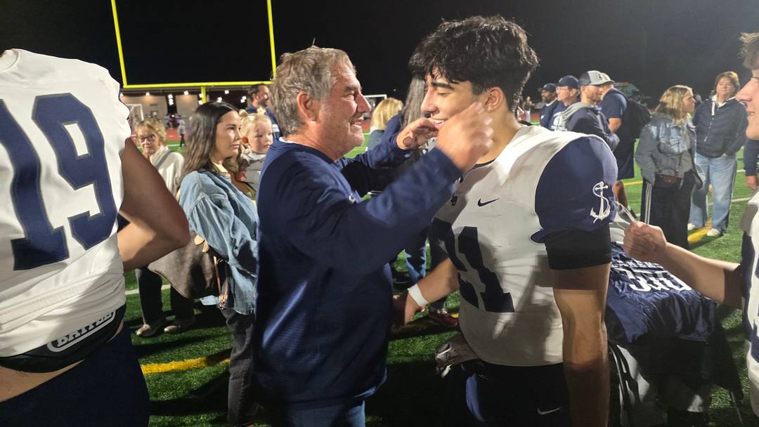 Lake Oswego coach Steve Coury celebrates with one of his players after capturing his 300th career win on Friday.