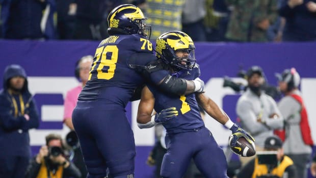 Michigan running back Donovan Edwards (7) celebrates a touchdown against Washington during the first half of the national cha