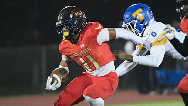 Xavier Lherisse of Eau Gallie escapes the grasp of Titusville’s Zymerius Brown in the FHSAA Class 3A football regional semifi