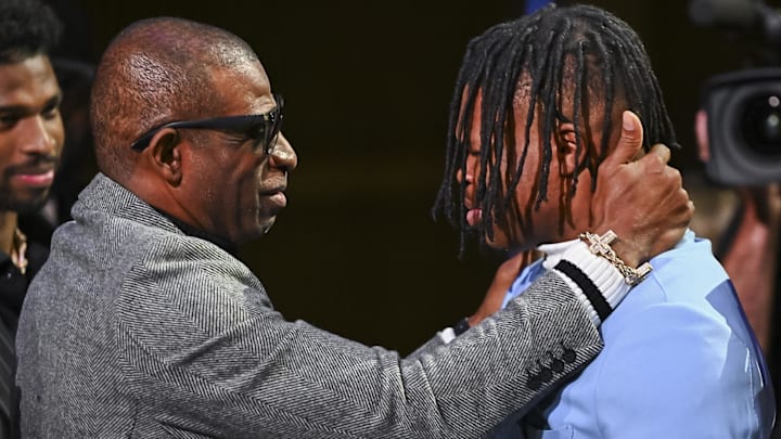 Colorado Buffaloes wide receiver/cornerback Travis Hunter with head coach Deion Sanders after winning the 2024 Heisman Trophy.