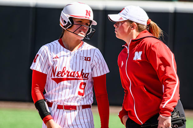 Hannah Camenzind chats with assistant coach Olivia Ferrell after a single. 