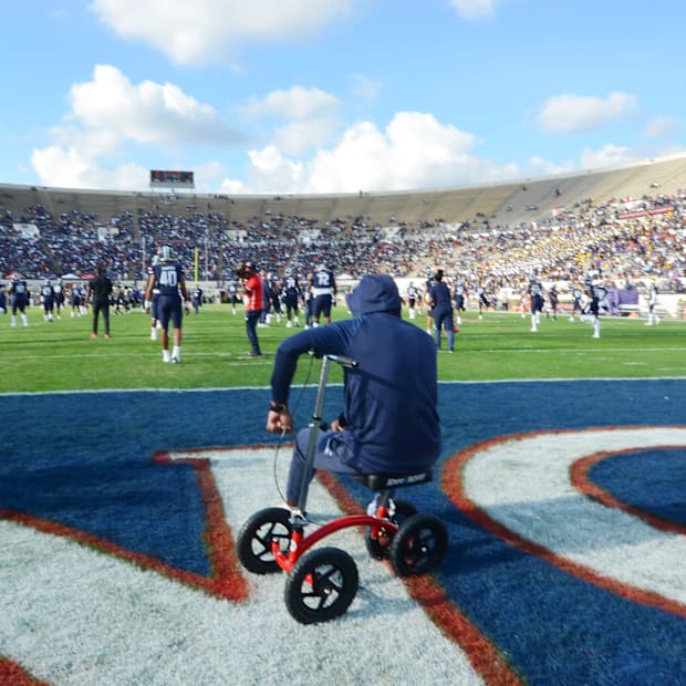 Jackson State head coach Deion Sanders watches the Tigers warm up before the SWAC Championship against Prairie View A&M a