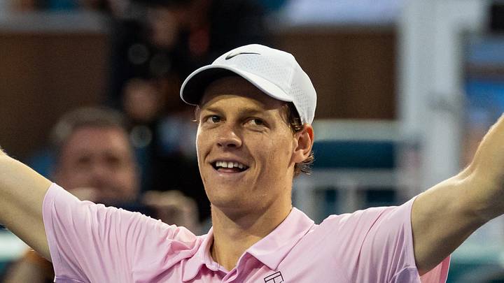 Jannik Sinner raises his hands in celebration