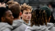 Michigan State's quarterback Alessio Milivojevic huddles with the team before the game against Penn State on Saturday, Nov. 15, 2025, at Spartan Stadium in East Lansing.