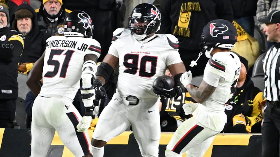 Houston Texans defensive tackle Sheldon Rankins (90) celebrates with teammates after returning a fumble for a touchdown.