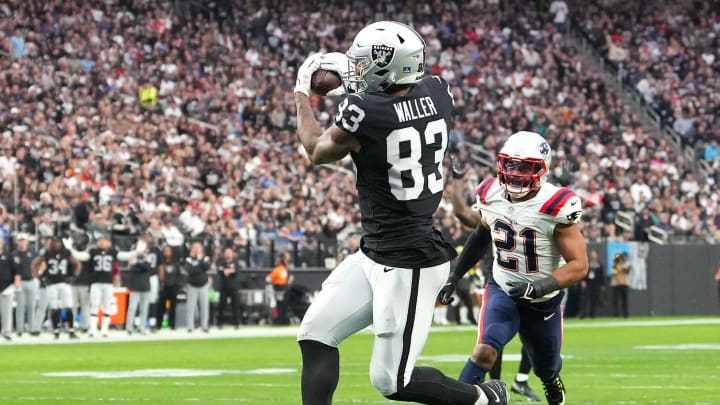 Dec 18, 2022; Paradise, Nevada, USA; Las Vegas Raiders tight end Darren Waller (83) makes a touchdown reception in front of New England Patriots safety Adrian Phillips (21) during the first half at Allegiant Stadium. Mandatory Credit: Stephen R. Sylvanie-USA TODAY Sports