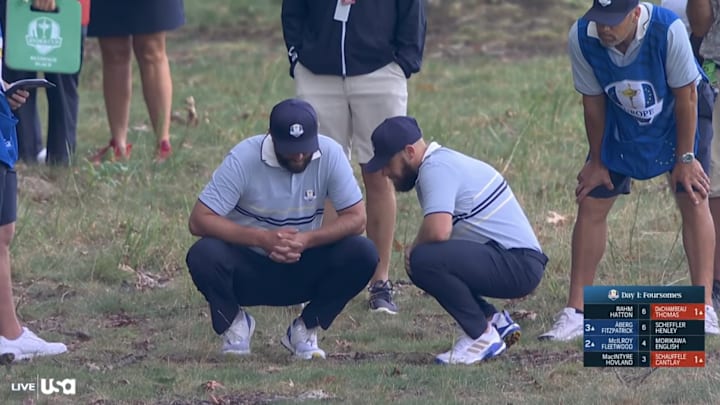 John Rahm and Tyrrell Hatton inspect a stick during the Ryder Cup. John Rahm and Tyrrell Hatton inspect a stick during the Ryder Cup.