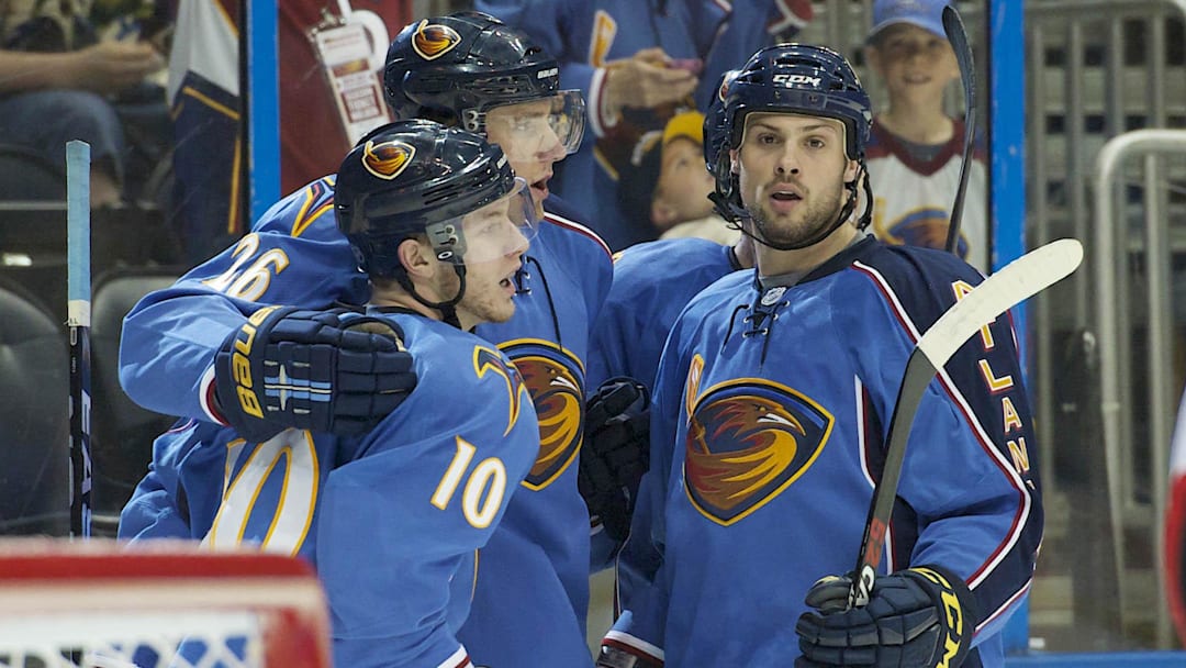 Mar 27, 2011; Atlanta, GA, USA; Atlanta Thrashers center Bryan Little (10) celebrates scoring a goal against the Ottawa Senators with right wing Blake Wheeler (26) and defenseman Zach Bogosian (4) in the second period at Philips Arena. Mandatory Credit: Dale Zanine-Imagn Images