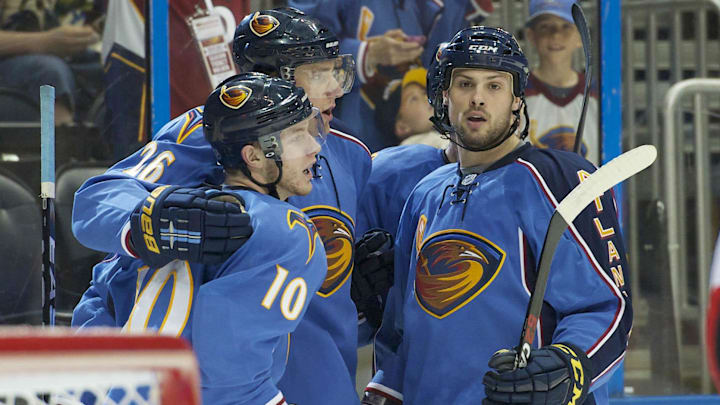 Mar 27, 2011; Atlanta, GA, USA; Atlanta Thrashers center Bryan Little (10) celebrates scoring a goal against the Ottawa Senators with right wing Blake Wheeler (26) and defenseman Zach Bogosian (4) in the second period at Philips Arena. Mandatory Credit: Dale Zanine-Imagn Images