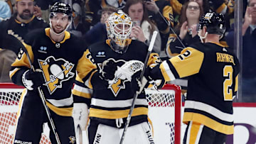 Dec 30, 2023; Pittsburgh, Pennsylvania, USA; Pittsburgh Penguins defenseman Marcus Pettersson (28) and goaltender Tristan Jarry (35) and defenseman Chad Ruhwedel (2) celebrate after defeating the St. Louis Blues at PPG Paints Arena. Pittsburgh won 4-2. Mandatory Credit: Charles LeClaire-Imagn Images