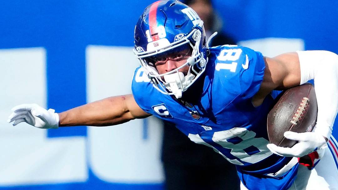 New York Giants wide receiver Darius Slayton (18) breaks a tackle attempt by Dallas Cowboys cornerback Corey Ballentine (36) before getting a Big Blue first down, Sunday, January 4, 2026, in East Rutherford.