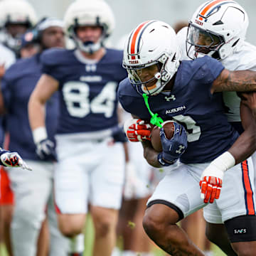 Auburn Wide Receiver Perry Thompson fights off linebackers Keyron Crawford and DJ Barber during spring practice. 