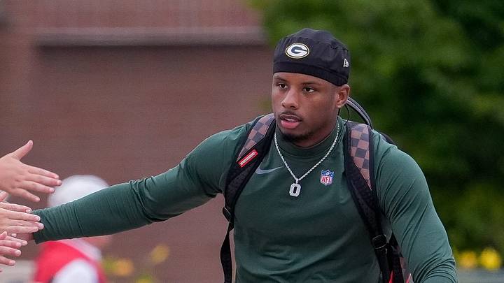 Green Bay Packers wide receiver Matthew Golden slaps hands with fans as he rides a bicycle to practice on Friday, July 31, 2026, at Lambeau Field in Green Bay, Wisconsin.