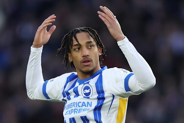 Joao Pedro celebrating with raised arms in a Brighton home kit