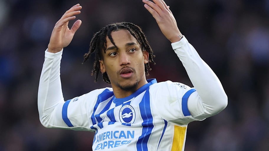 Joao Pedro celebrating with raised arms in a Brighton home kit