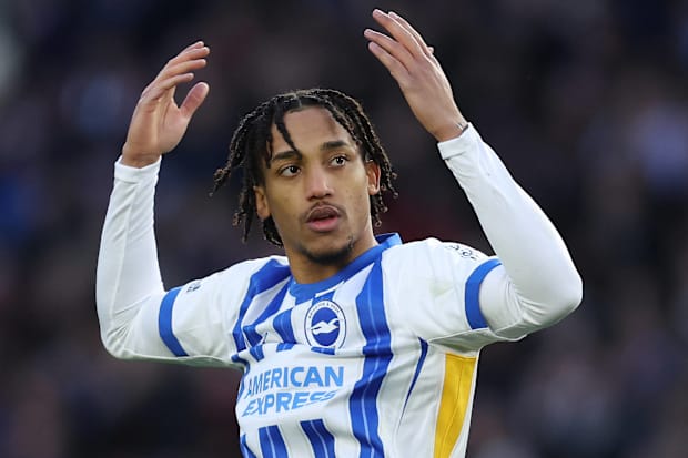 Joao Pedro celebrating with raised arms in a Brighton home kit