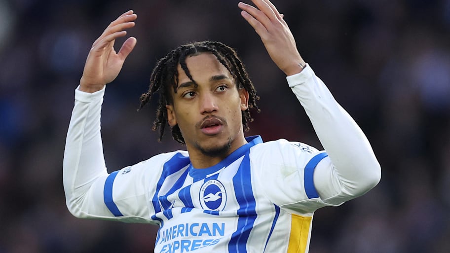 Joao Pedro celebrating with raised arms in a Brighton home kit