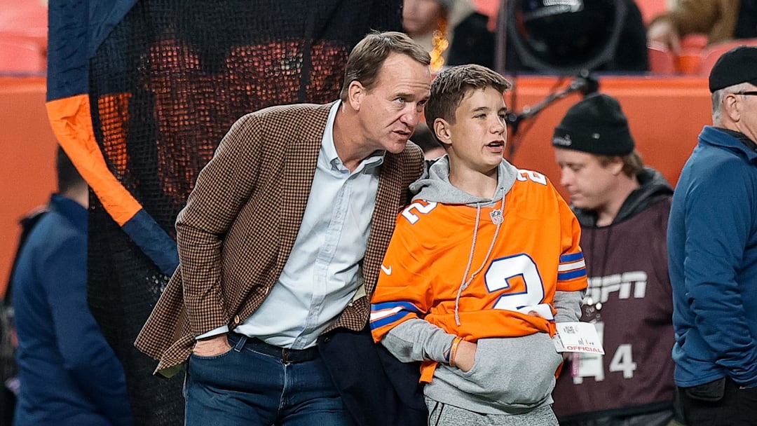 Dec 2, 2024; Denver, Colorado, USA; Former Denver Broncos player Peyton Manning with his son Marshall before the game against the Cleveland Browns at Empower Field at Mile High. Mandatory Credit: Isaiah J. Downing-Imagn Images