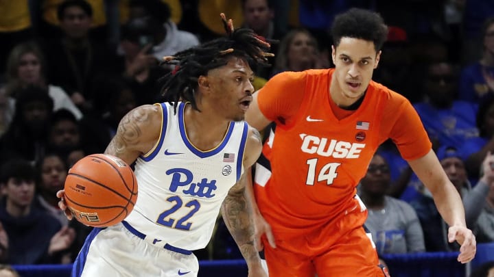 Feb 25, 2023; Pittsburgh, Pennsylvania, USA;  Pittsburgh Panthers guard Nike Sibande (22) brings the ball up court as Syracuse Orange center Jesse Edwards (14) chases during the first half  at the Petersen Events Center. Mandatory Credit: Charles LeClaire-USA TODAY Sports