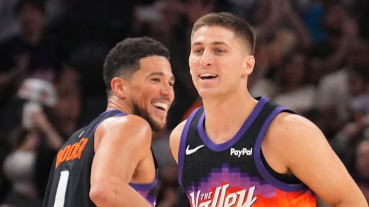 Phoenix Suns guard Devin Booker and teammate Collin Gillespie react against the Charlotte Hornets during the second half at Mortgage Matchup Center.