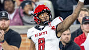 Sep 11, 2025; Winston-Salem, North Carolina, North Carolina State Wolfpack wide receiver Keenan Jackson (8) celebrates a first down against the Wake Forest Demon Deacons defensive back Karon Prunty (3) in second half at Allegacy Federal Credit Union Stadium. Mandatory Credit: Luke Jamroz-Imagn Images 