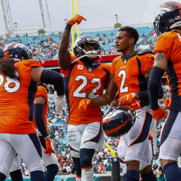 Denver Broncos strong safety Kareem Jackson (22) celebrates after a reception by cornerback Pat Surtain II (2) in the fourth quarter against the Jacksonville Jaguars at TIAA Bank Field. 