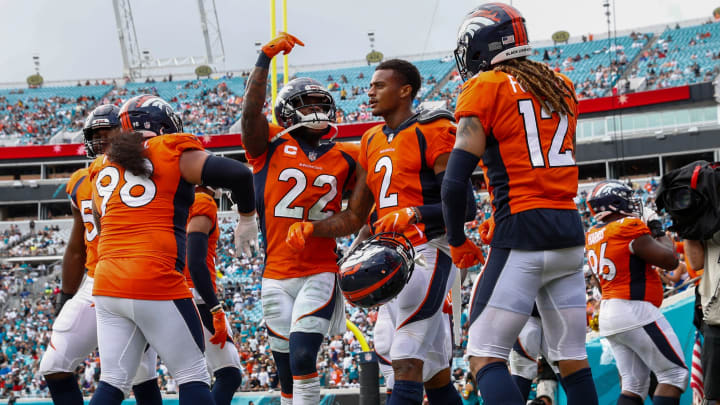 Denver Broncos strong safety Kareem Jackson (22) celebrates after a reception by cornerback Pat Surtain II (2) in the fourth quarter against the Jacksonville Jaguars at TIAA Bank Field. 