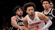 Dec 23, 2023; Brooklyn, New York, USA; Detroit Pistons guard Cade Cunningham (2) drives to the basket against Brooklyn Nets guard Cam Thomas (24) and forward Cameron Johnson (2) during the fourth quarter at Barclays Center. Mandatory Credit: Brad Penner-Imagn Images