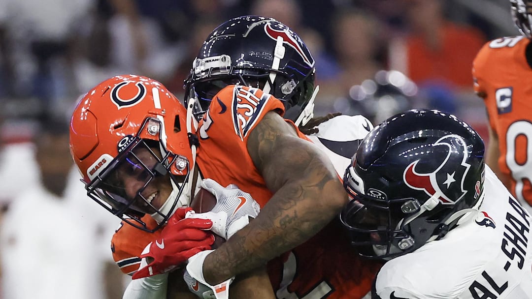 Sep 15, 2024; Houston, Texas, USA; Chicago Bears wide receiver DJ Moore (2) is tackled by Houston Texans linebacker Azeez Al-Shaair (0) in the first quarter at NRG Stadium. Mandatory Credit: Thomas Shea-Imagn Images