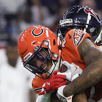 Sep 15, 2024; Houston, Texas, USA; Chicago Bears wide receiver DJ Moore (2) is tackled by Houston Texans linebacker Azeez Al-Shaair (0) in the first quarter at NRG Stadium. Mandatory Credit: Thomas Shea-Imagn Images