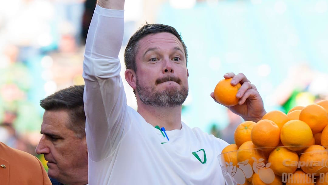 Oregon head coach Dan Lanning, left, throws out oranges as the team celebrates its win as the Oregon Ducks take on the Texas Tech Red Raiders in the Orange Bowl on Jan. 1, 2026, at Hard Rock Stadium in Miami, Florida.