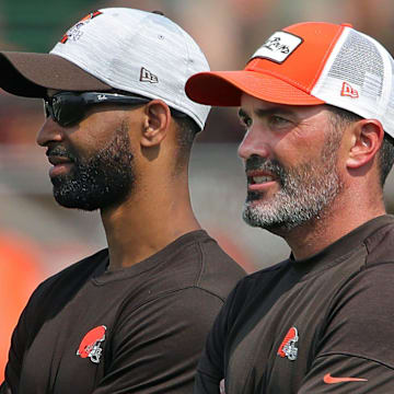 Browns GM Andrew Berry, left, and coach Kevin Stefanski watch practice in training camp, Saturday, July 31, 2021, in Berea.