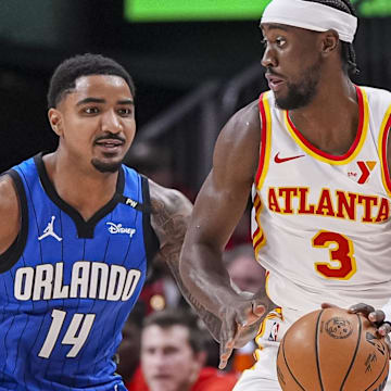 Feb 20, 2025; Atlanta, Georgia, USA; Atlanta Hawks guard Caris LeVert (3) dribbles in front of Orlando Magic guard Gary Harris (14) during the first half at State Farm Arena. Mandatory Credit: Dale Zanine-Imagn Images