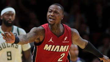 Nov 26, 2024; Miami, Florida, USA; Miami Heat guard Terry Rozier (2) reacts toward referee Tom Washington (49) after shooting the basketball against the Milwaukee Bucks during the fourth quarter at Kaseya Center. Mandatory Credit: Sam Navarro-Imagn Images