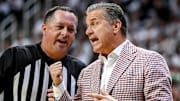 Arkansas coach John Calipari, right, argues with a referee during the first half against Michigan State.