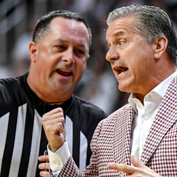 Arkansas coach John Calipari, right, argues with a referee during the first half against Michigan State.
