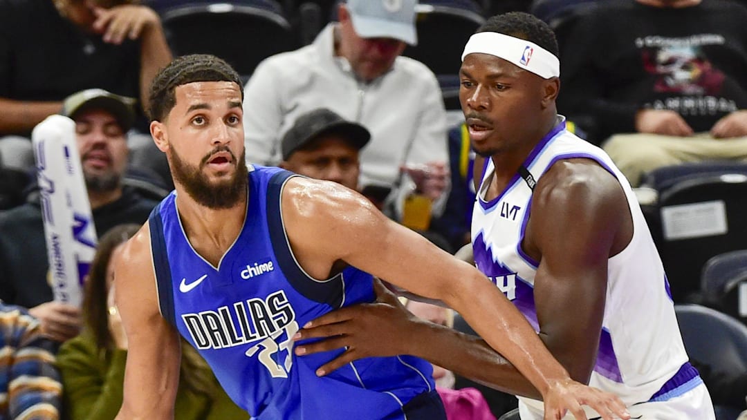 Oct 13, 2025; Salt Lake City, Utah, USA; Dallas Mavericks forward/center Jeremiah Robinson-Earl (23) looks for an open man during the second half while being guarded by Utah Jazz forward/center Oscar Tshiebwe (34) at Delta Center.